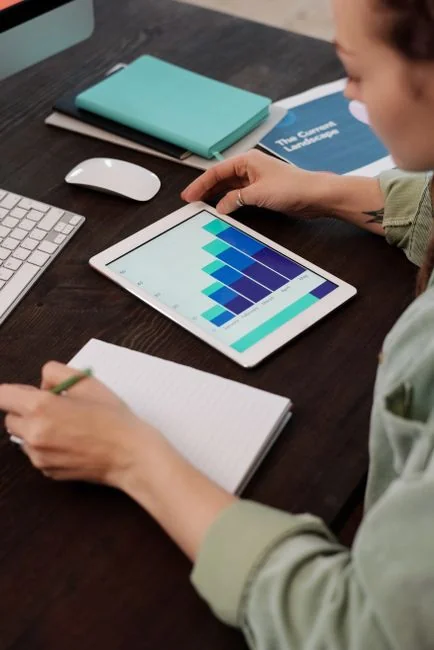 Close-up of a woman working on a digital marketing project in a home office setting.